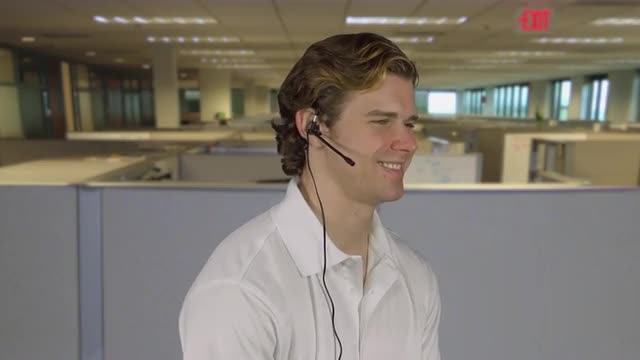 Professional male talks to customer in an office