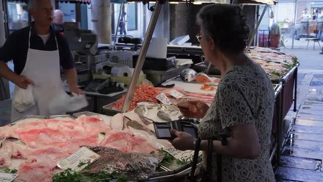 MH Customer Buying Fish in Market / Venice, Italy