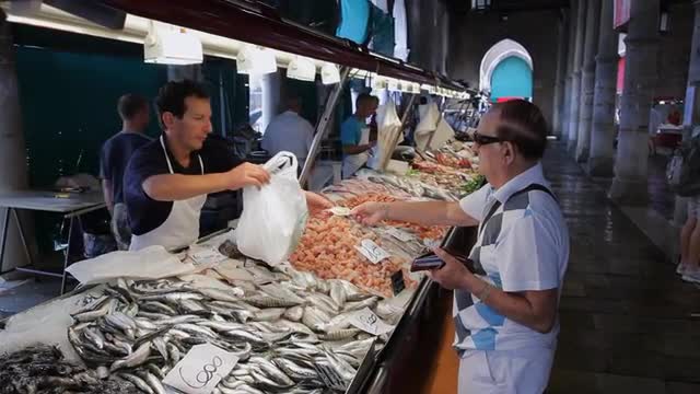 MH Customer Buying Fish in Market / Venice, Italy