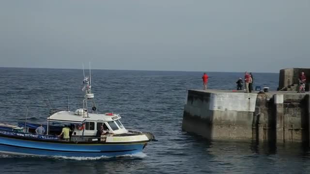 WS PAN Fishing Boat Going Past Lighthouse / Cornwall, England, UK