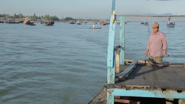 WS Man Steering His Boat in Water / Vietnam