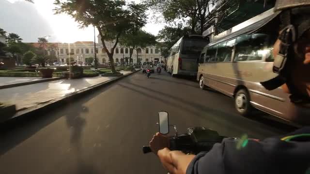 POV WS Motorcycle Driving down Busy Street / Ho Chi Minh, Vietnam