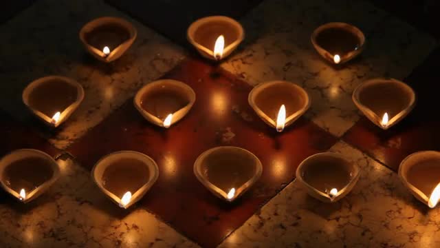 MS HA Burning clay oil lamps on tiled floor / Singapore