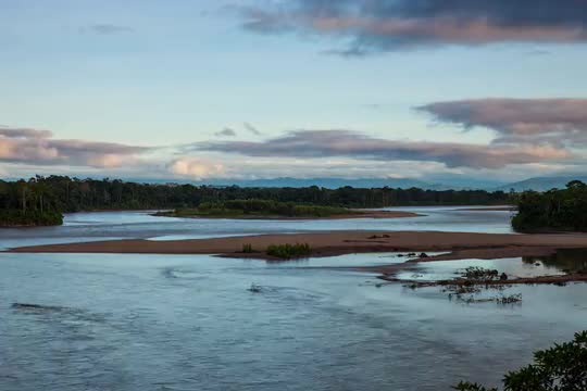Timelapse of rainforest river moving at sunset + cloudscape