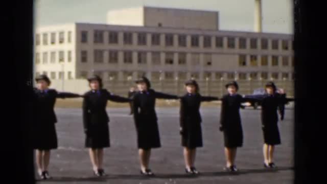 1947: military women in dark uniforms stand in formation one arm length away NEW YORK