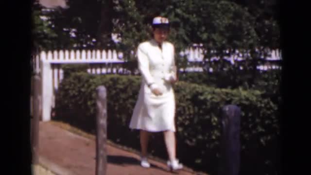 1947: the woman was walking in pathway NEW YORK