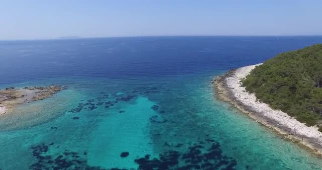 Drone, aerial scene. Island in the Dalmatian coast. Transparent water. Aerial scene, camera goes up.
