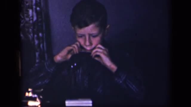 1942: school aged boy playing harmonica SEBRING OHIO