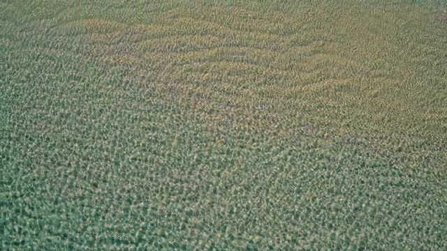 Aerial View Takeoff from Surface Ocean
