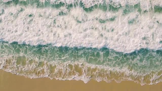 Aerial View Small Waves on Sandy Beach