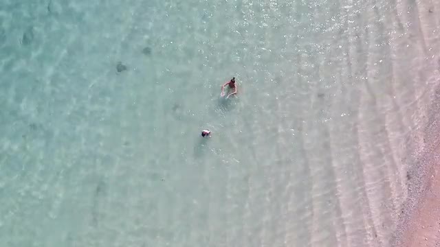 Top View of Mother and Son Swimming and Having Fun in the Water