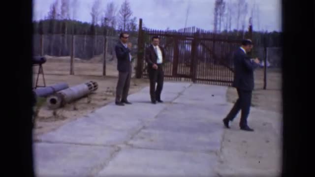 1971: three men look at three metal tubes placed within outdoor enclosure MOSCOW RUSSIA