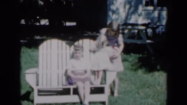 1961: three sisters pose and wave from backyard bench. MISSOURI