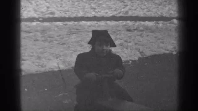 1947: a small child, outdoors on a playground, being lifted up and down on a teeter totter NEW YORK