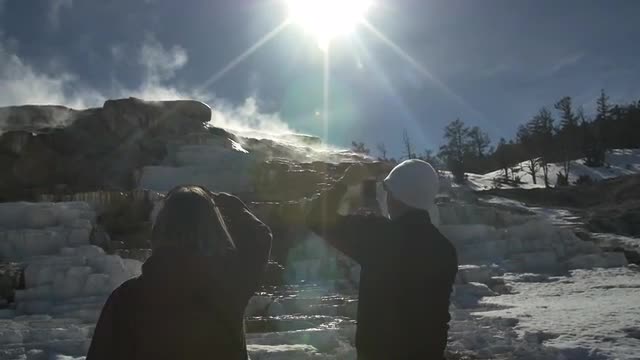 Tourists gazing on the thermal springs in Yellowstone National Park