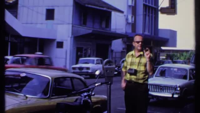 1969: a man standing platform of the road and using walkie-talkie for speaking THAILAND