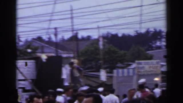 1953: bustling crowd at an event in a town JAPAN
