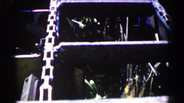 1963: a chained ladder spine like a train a iron chain tightly tied surround the iron ladder MONTGOM