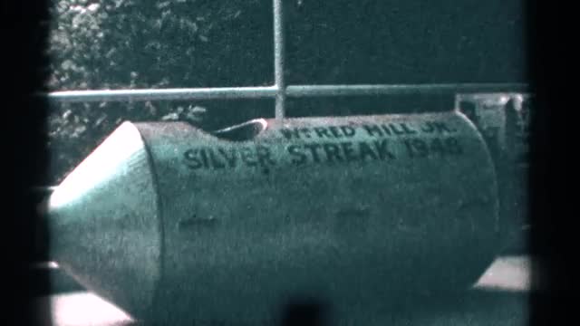 1964: metal, cylindrical item, with cone-shaped tip, lettering, seat area. NIAGRA FALLS CANADA
