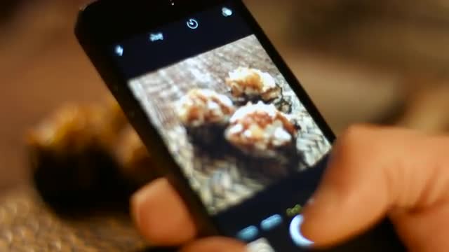 The man on the smartphone photography food seafood cooking sushi Asian cuisine. 
