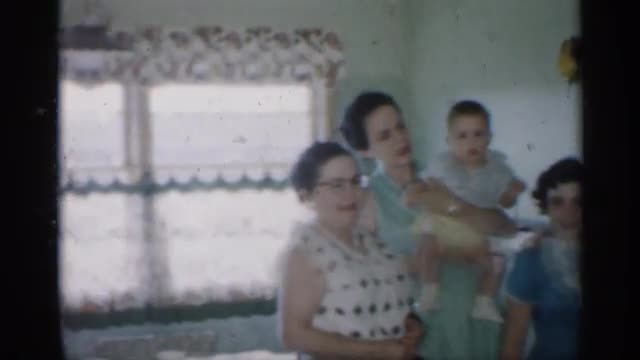 1958: three generations of women pose for a picture/video: grandmother, sisters and grandchildren. N