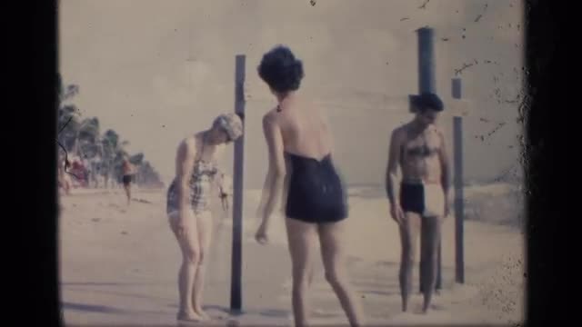 1959: people spending time together in beach with family and playing in tides and an match of beach 