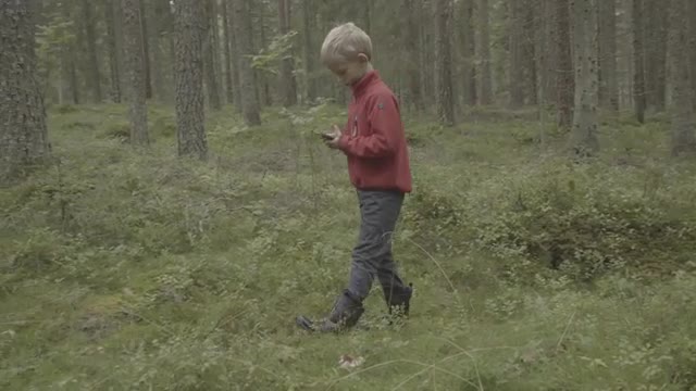 Pokemon player wlaking in forest