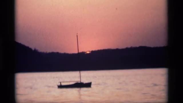 1969: one board move in the river evening time sun shine set that boat set the men HOLLAND MICHIGAN