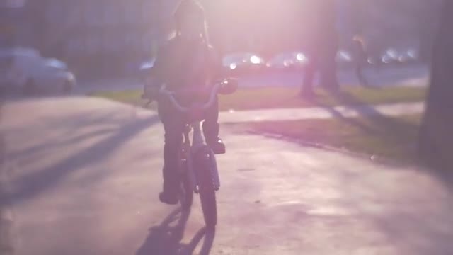 Fair-Haired Girl Goes For Drive on Pink Bicycle