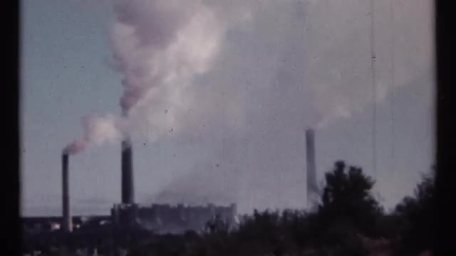 1967: white smoke is flowing upwards from three tall cylindrical chimneys OTTAWA CANADA