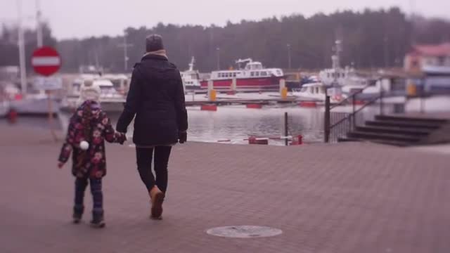 Mum and Hers Minor Daughter Walk Along River Bank
