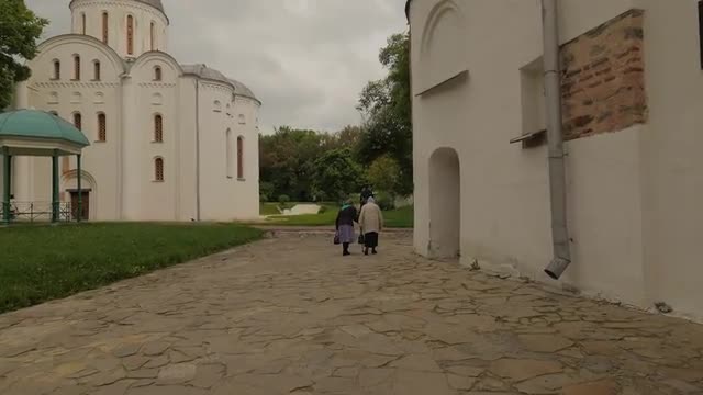 Senior Women Walking by Alley of Church Courtyard Ancient Restored Religious Buildings Architectural