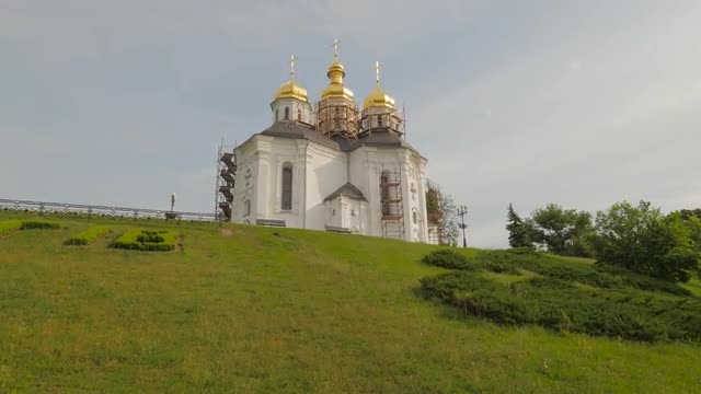 Renovated Orthodox Church on Green Hill Springtime Fresh Landscape Sun Shines Through the Clouds Tou
