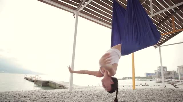 Anti-gravity Yoga, woman doing yoga exercises