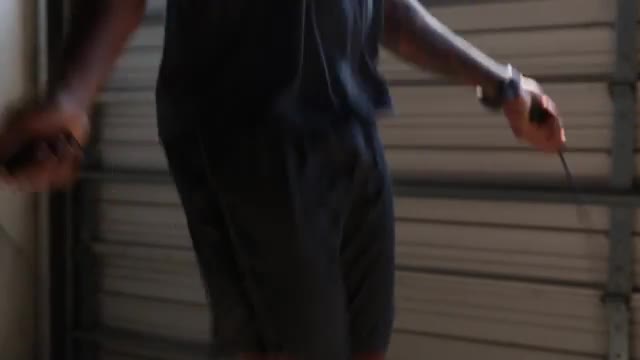 Close up of midsection of African American man jumping rope