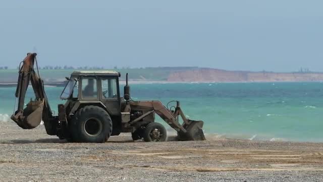 Tractor Working On The Beach