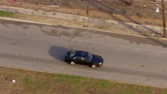 WS POV AERIAL TS ZI ZO Car moving on road in  destructed suburban area / United States