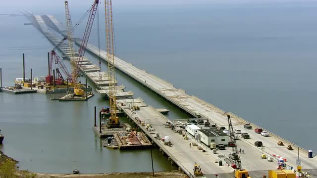 MS POV AERIAL Causeway being repaired, view of cranes at causeway / United States