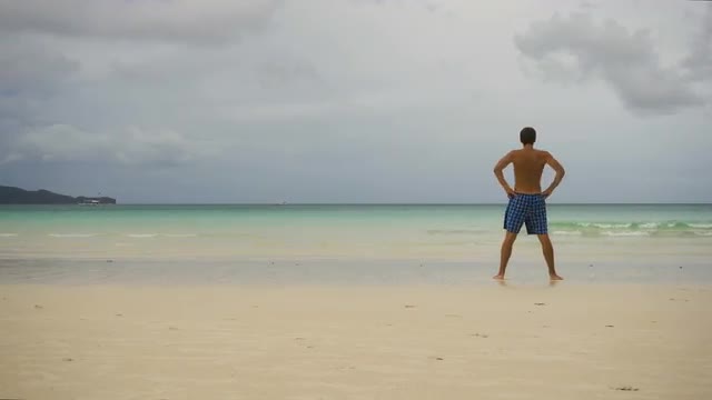 Man doing morning exercises at the beach.
