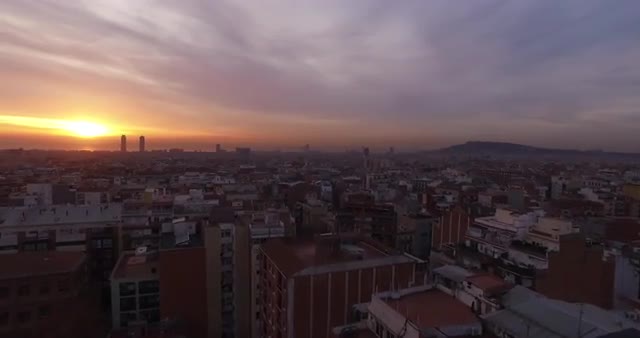Aerial over Barcelona towards the sunset
