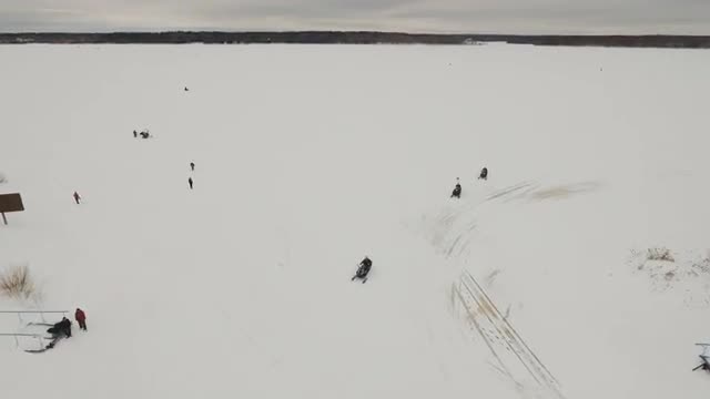 Racing on a snowmobile.
