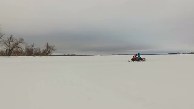 Racing on a snowmobile.