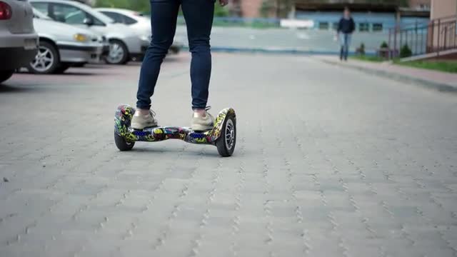 Riding Hoverboard or Electric Self Balancing Gyro Scooter Board on the Side Walk