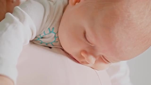 Mom Changes the Diaper of a Small Baby