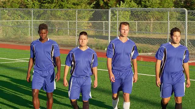 Soccer players walking onto the field