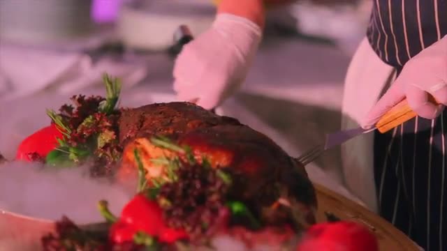 Chef Cuts Whole Pork on Cutting Board