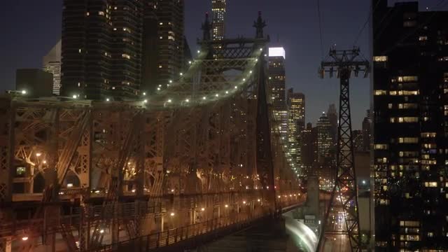 stunning hyper lapse shot of illuminated bridge road city panorama at night