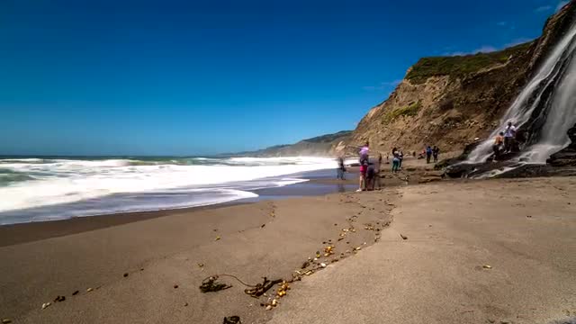 Motion time lapse of waterfall flowing into the ocean Motion time lapse of waterfall flowing into the ocean