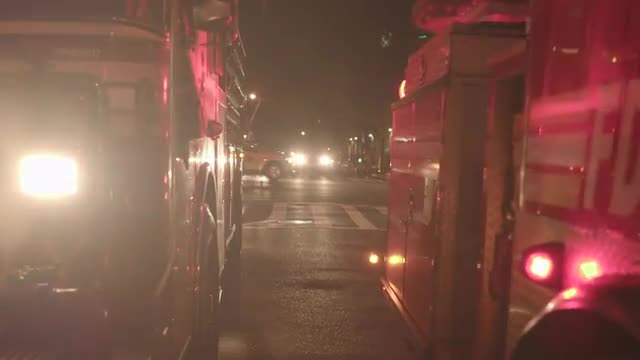 rescue emergency scene of fire trucks in the city at night