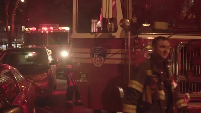 firemen entering fire trucks after successful rescue service